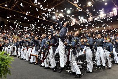Cadets toss their gloves into the air during the graduation ceremony held in Cameron Hall today.
